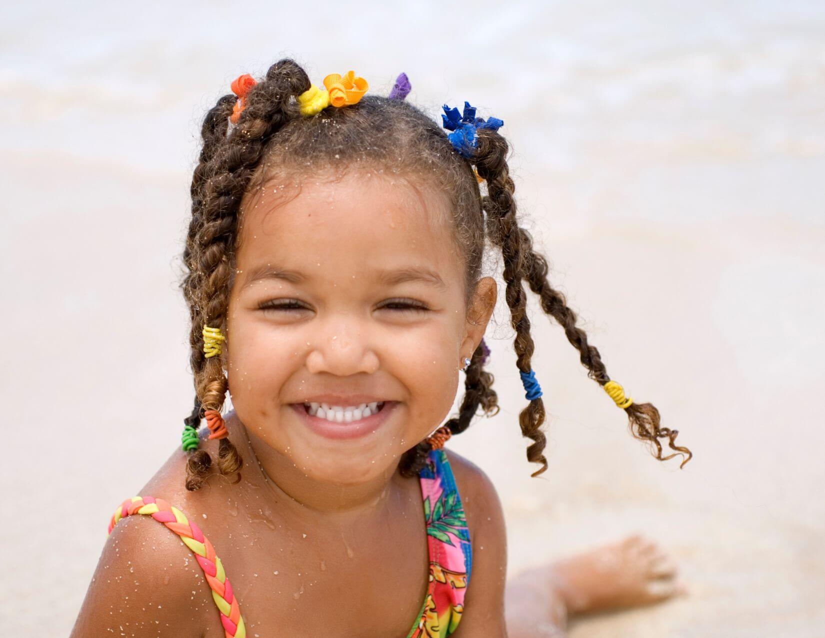 Smiling young girl with braided hair.